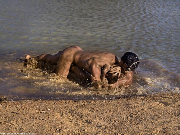 two muscle man playing